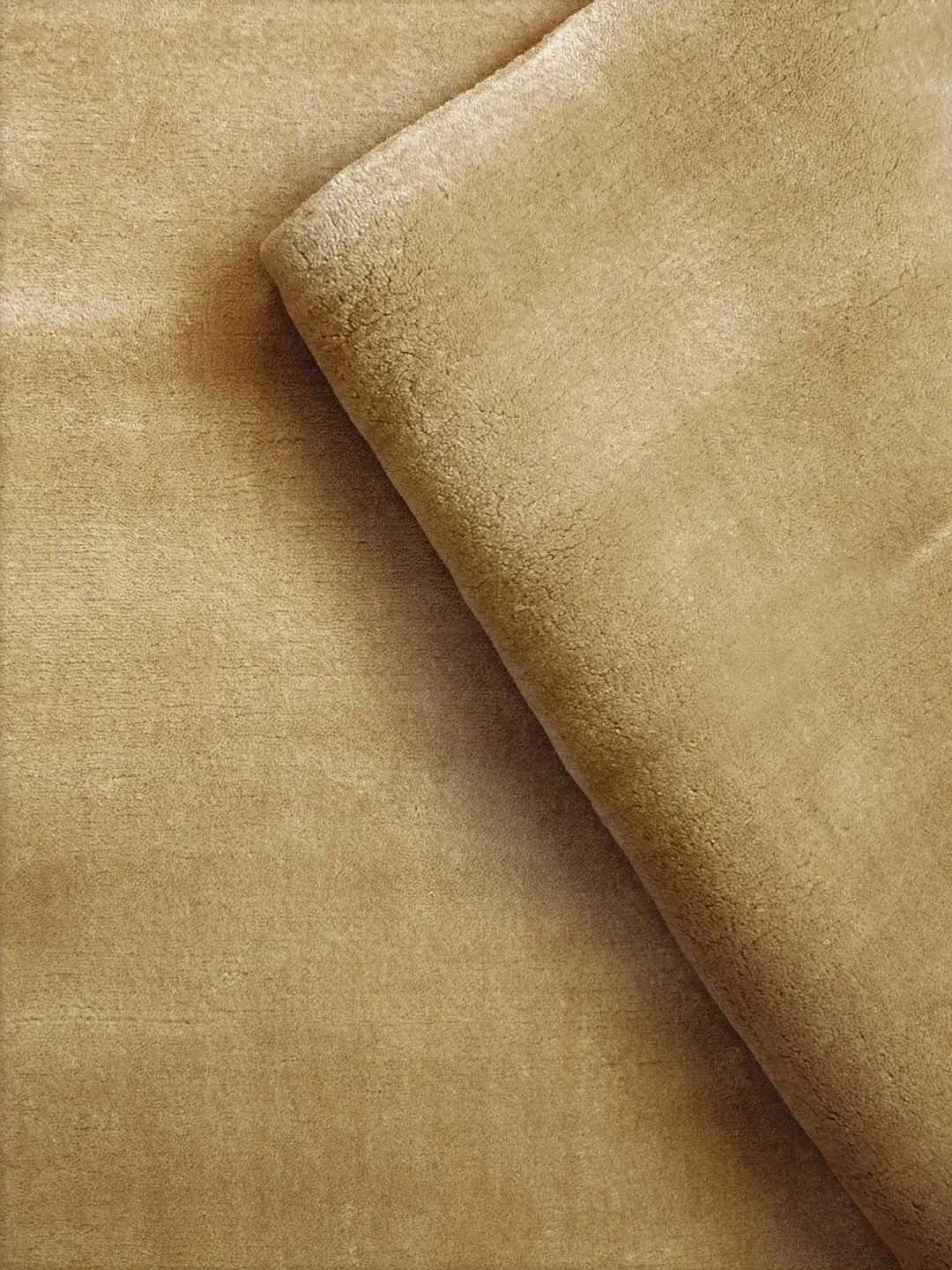 Cashmere Caramel rug rolled corner showing pile softness