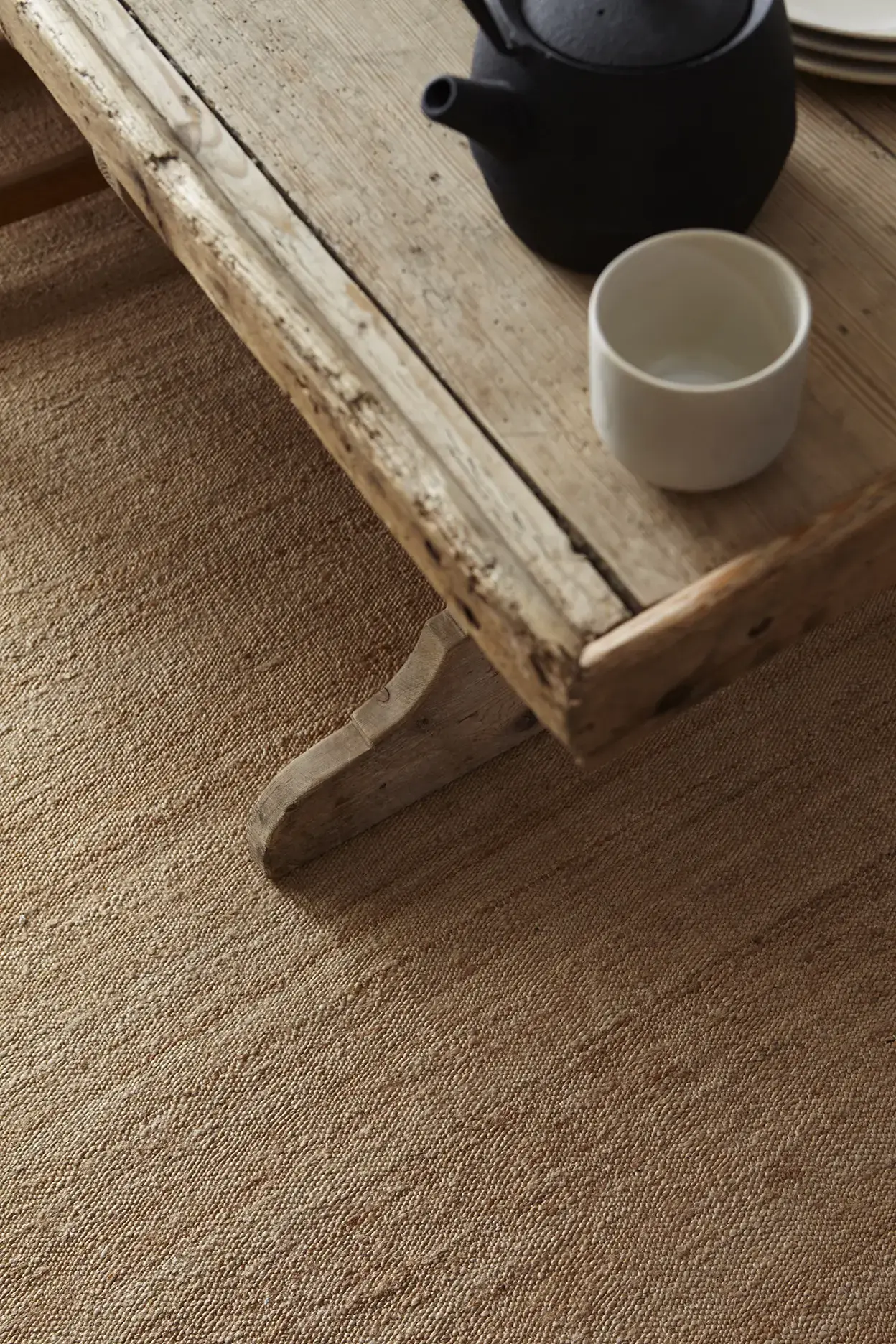 Sabi Natural jute rug detail with teapot on wooden table