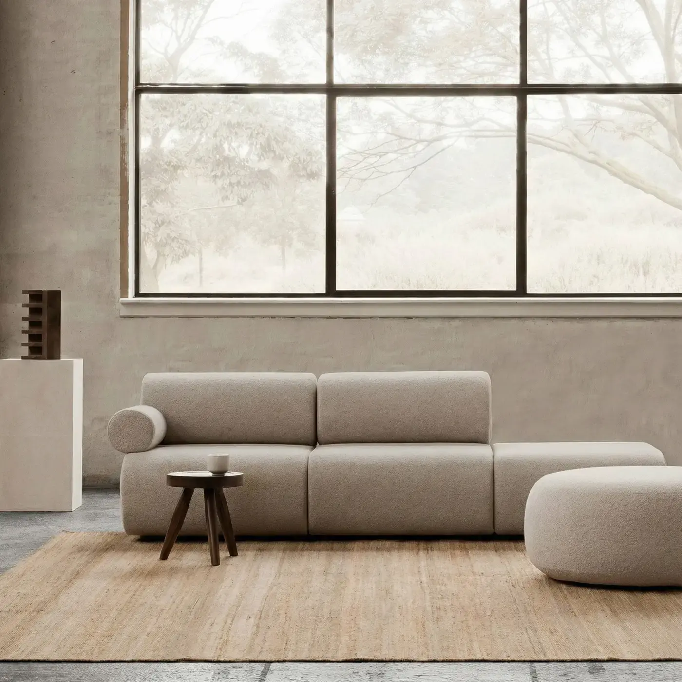 Sabi Natural jute rug in modern living room with curved sofa