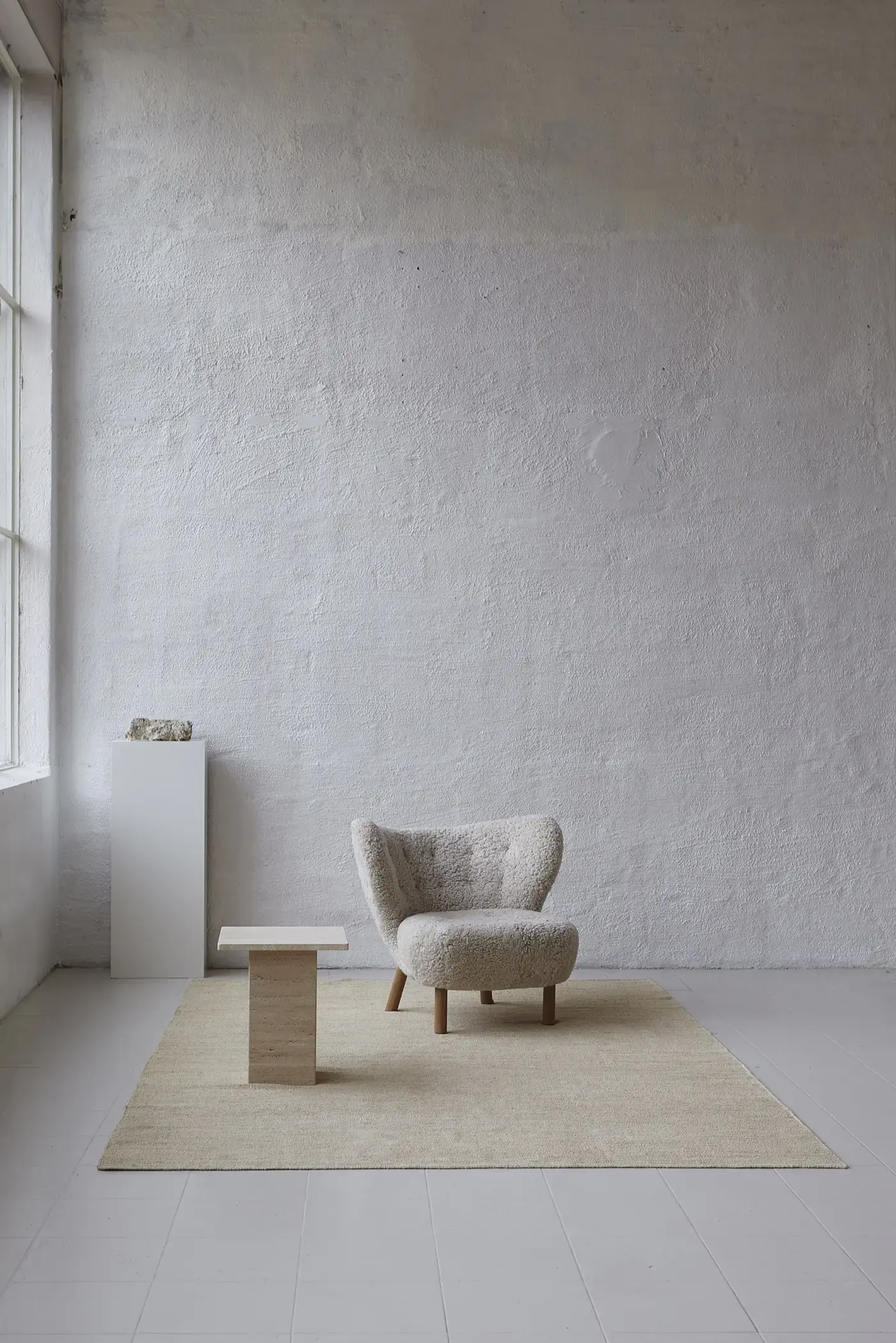 Sabi Sand jute rug in studio with sherpa chair and marble table