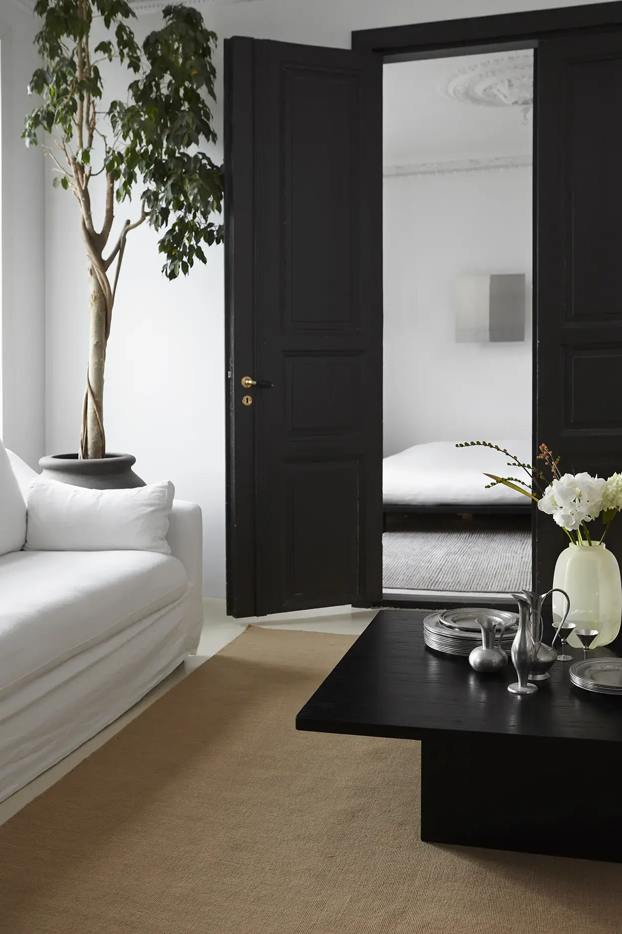 Yuka Caramel rug with white sofa and indoor tree