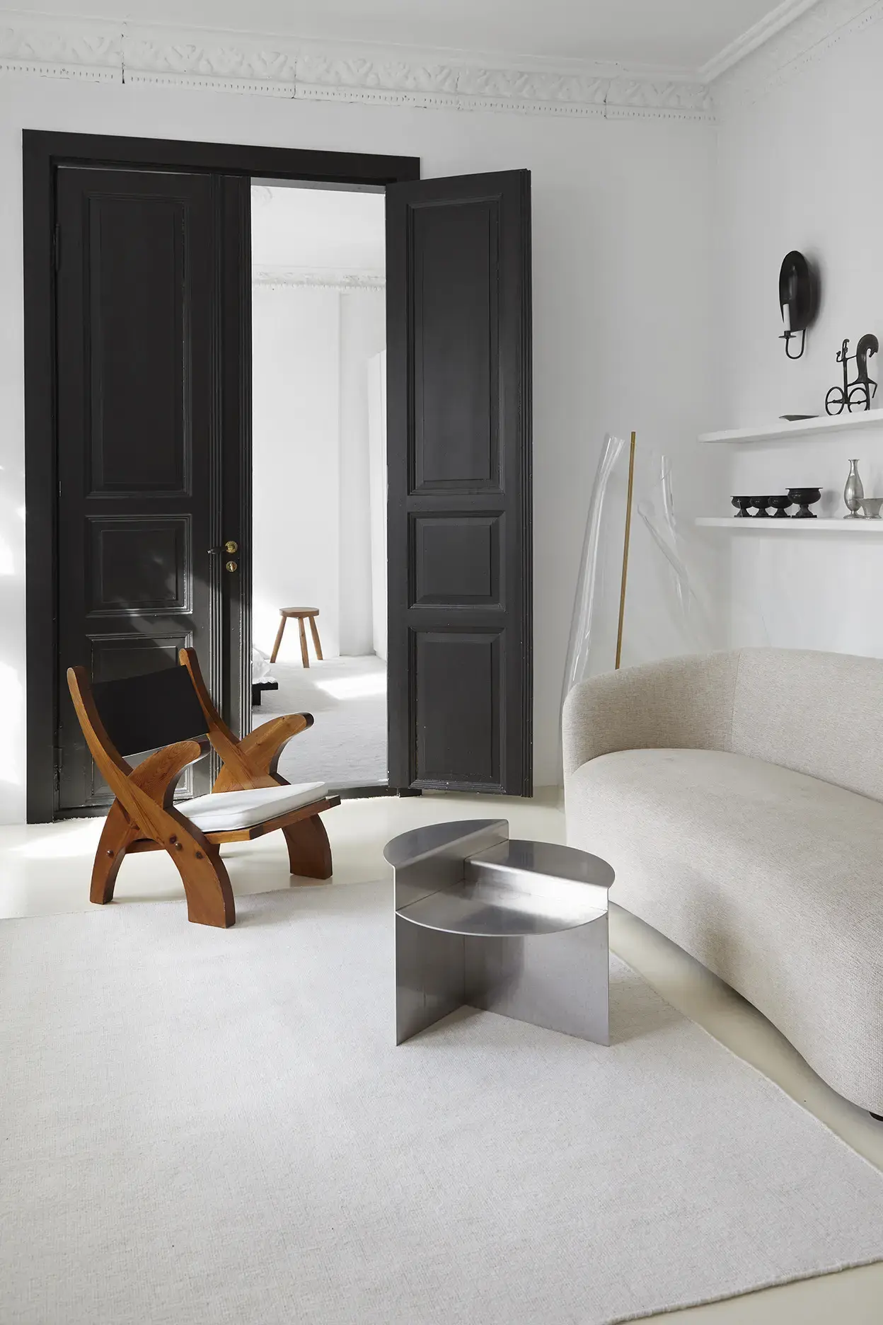 Yuka Clay flatweave rug in living room with cross-legged chair and curved sofa