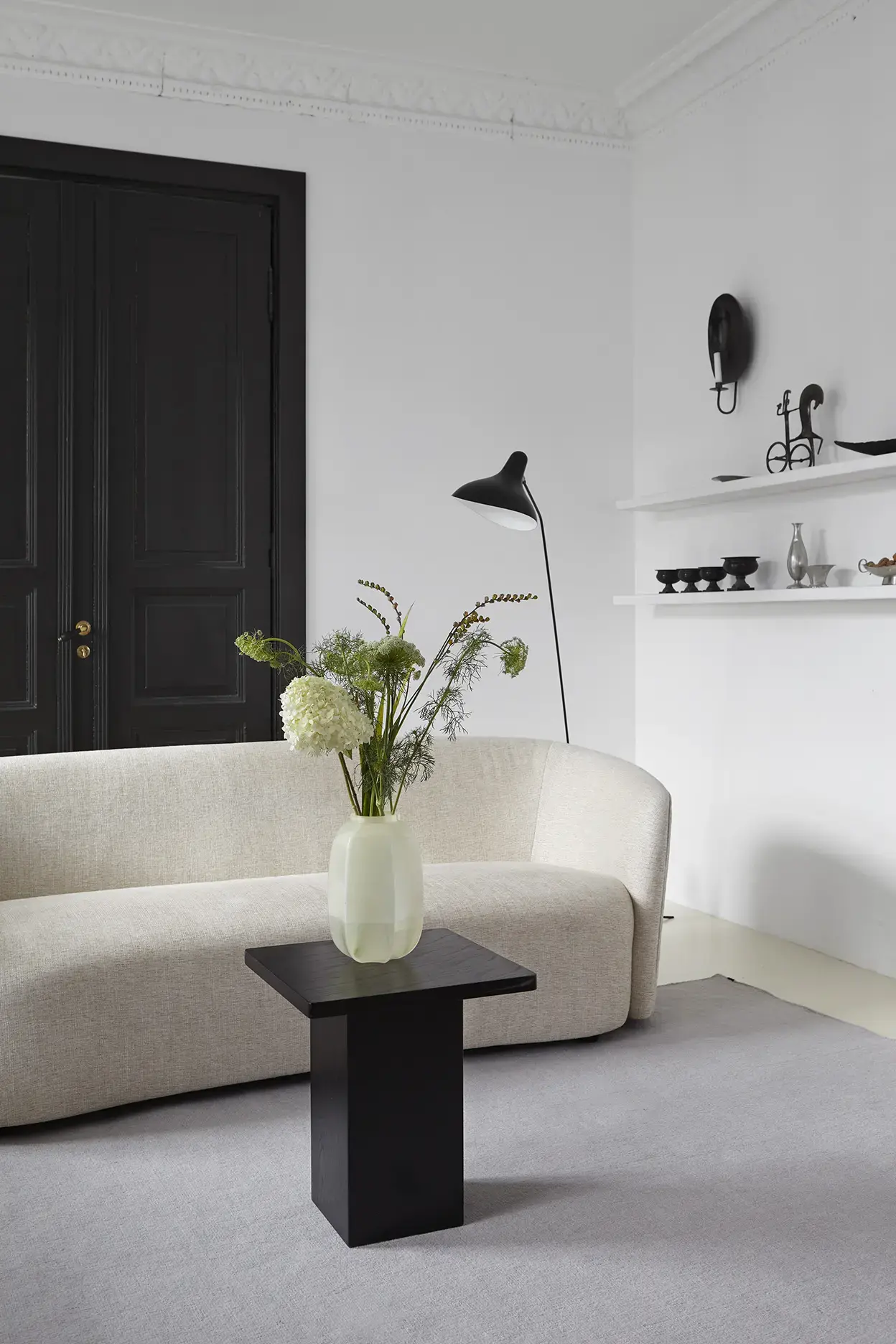 Yuka Misty Sky flatweave rug in living room with cream sofa and black table