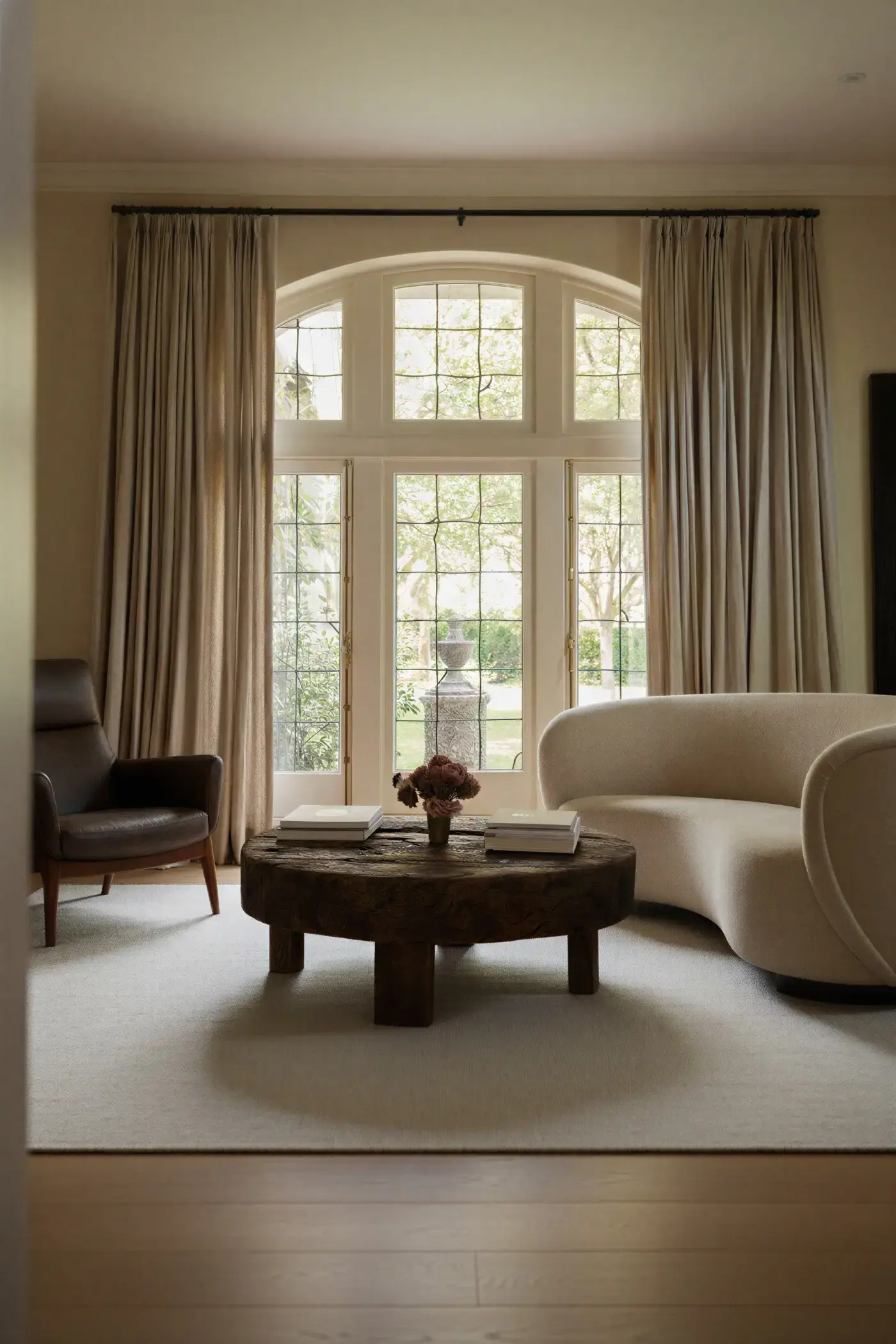 Yuka Misty Sky rug in elegant living room with arched window and curved sofa